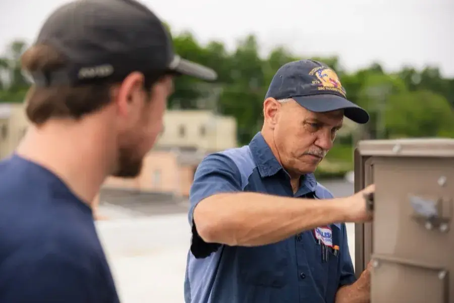 Callison electricians troubleshooting a control panel together on a service call in Augusta County, Virginia