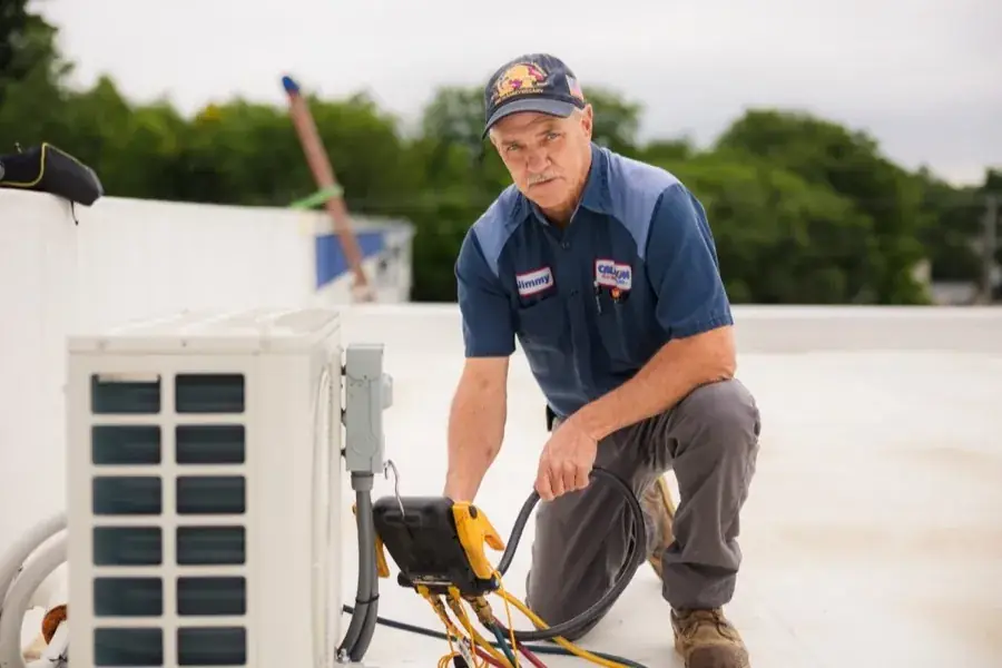 Callison technician Jimmy charging a ductless mini-split heat pump on a rooftop in Augusta County, Virginia