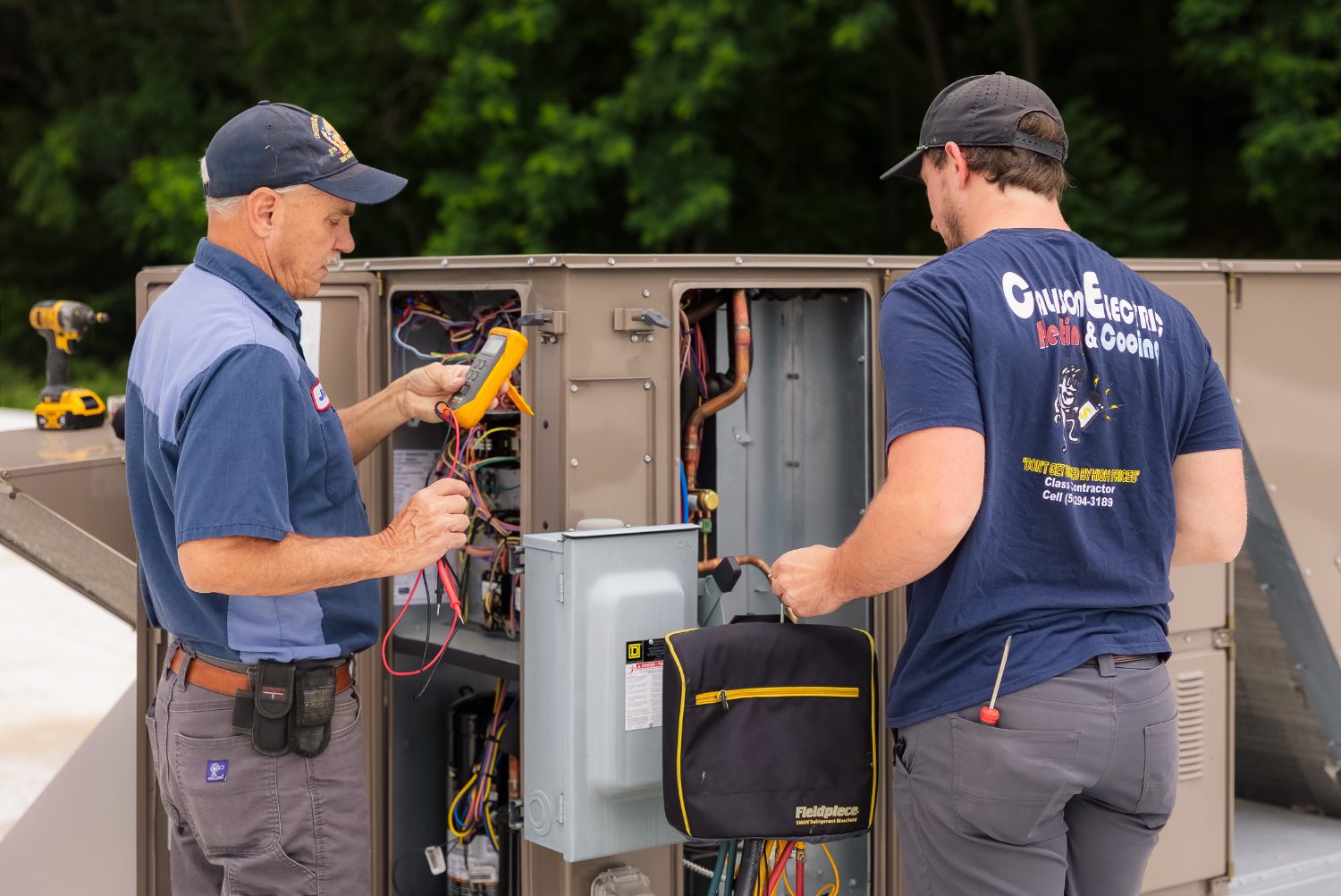Callison HVAC technicians servicing a rooftop unit together in Staunton, Virginia